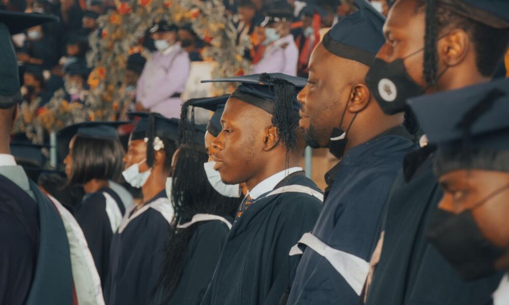 Graduands in academic gowns and caps lined up at a university convocation ceremony