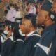 Graduands in academic gowns and caps lined up at a university convocation ceremony