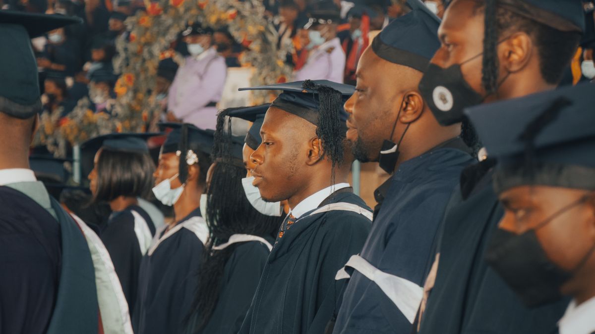 Graduands in academic gowns and caps lined up at a university convocation ceremony