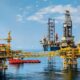 Offshore oil production platform and drilling rig on open water