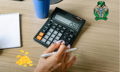 A table with a hand calculator and a CBN logo embedded