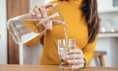 Water poured out of a jar into a glass cup
