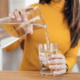 Water poured out of a jar into a glass cup