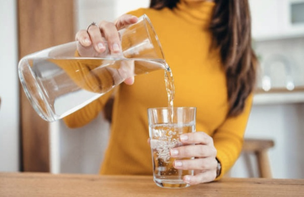 Water poured out of a jar into a glass cup