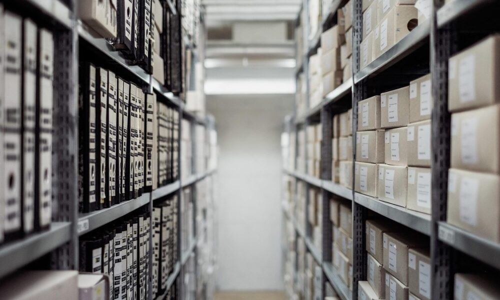 Rows of archived document boxes in a records storage room