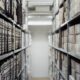 Rows of archived document boxes in a records storage room