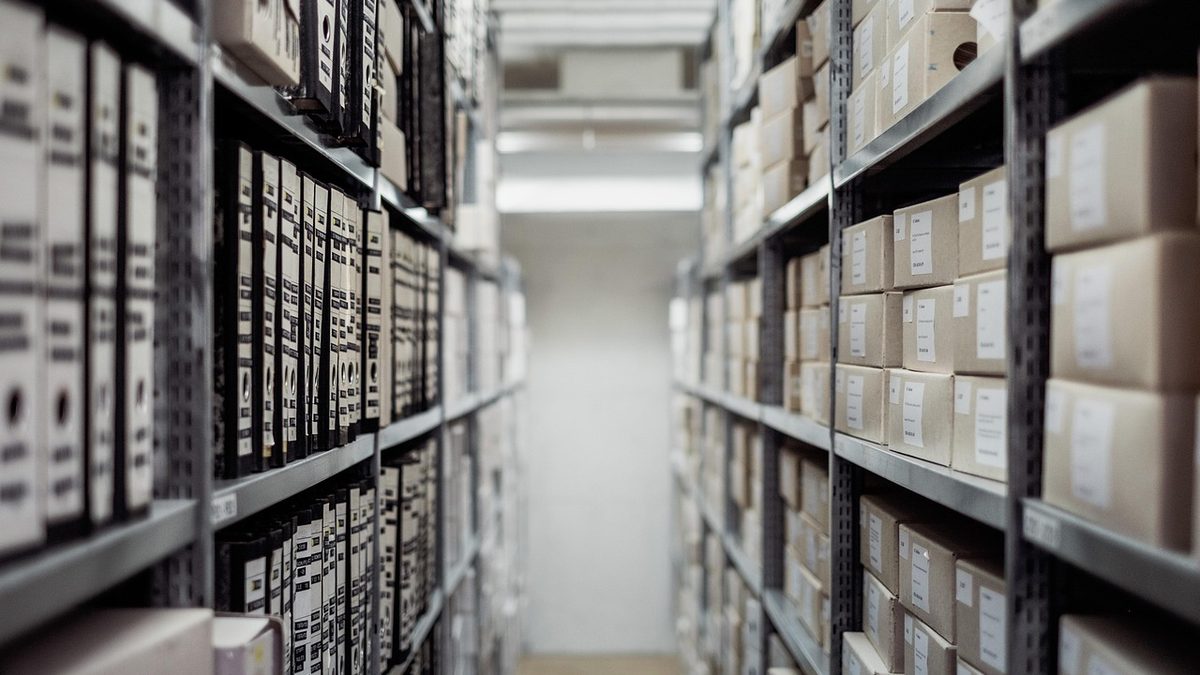 Rows of archived document boxes in a records storage room